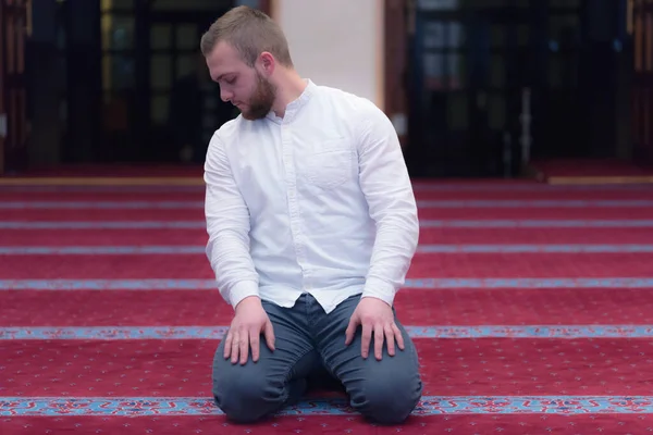 Young religious european muslim man praying inside the beautiful — Stock Photo, Image