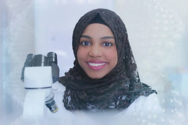 Young african muslim woman scientific working at lab with test t. —  Fotos de Stock
