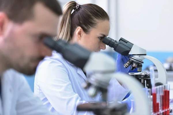 Two Young Female and male Laboratory scientists working at lab w