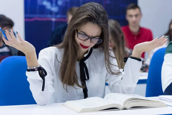 Young female student in math class overwhelmed by the math formu