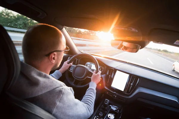 Man driving a car. Success in motion. Handsome young man driving a car. A man holds the steering wheel of a car. — Stock Photo, Image