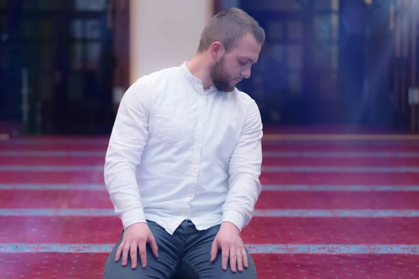 Young religious european muslim man praying inside the beautiful — Stock Photo, Image