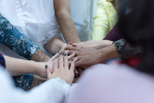 Multiracial Group of college students with Hands in Stack, Teamwork