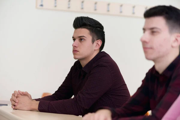 Exams Preparation. Group Of Multi-Ethnic Students Studying Together inside classroom while helping each other.