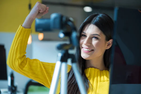 Attractive female blogger recording video for vlog. Gorgeous female coach and blogger giving antistress advice to her followers on video.