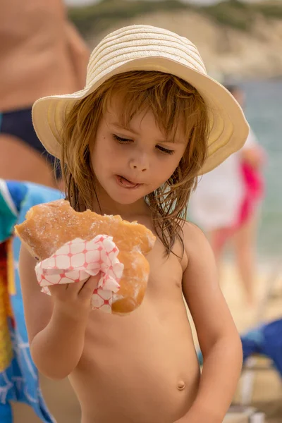 Meisje Eet Een Donut Het Strand — Stockfoto