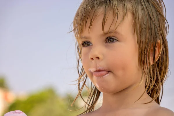 face of a little girl dirty with ice cream