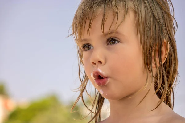 face of a little girl dirty with ice cream