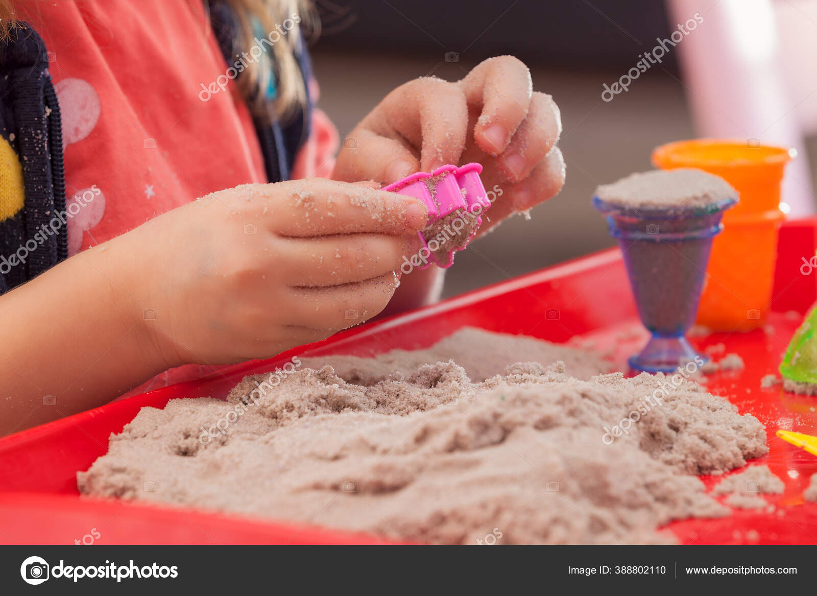 Little Hands Playing Kinetic Sand Molds Red Tra Stock Photo by