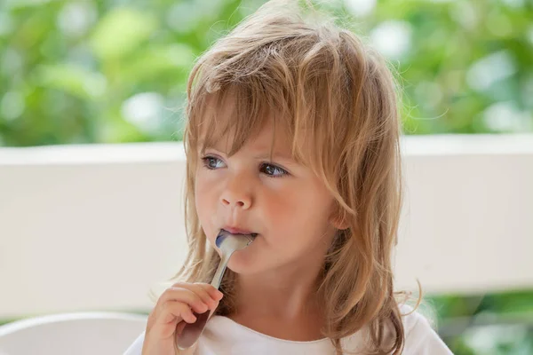 Little Girl Eats Honey Spoon — Stock Photo, Image