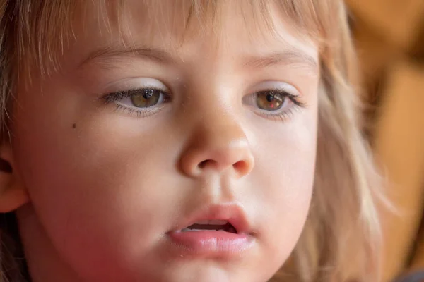 A girl\'s face expression while eating ice cream in close-up