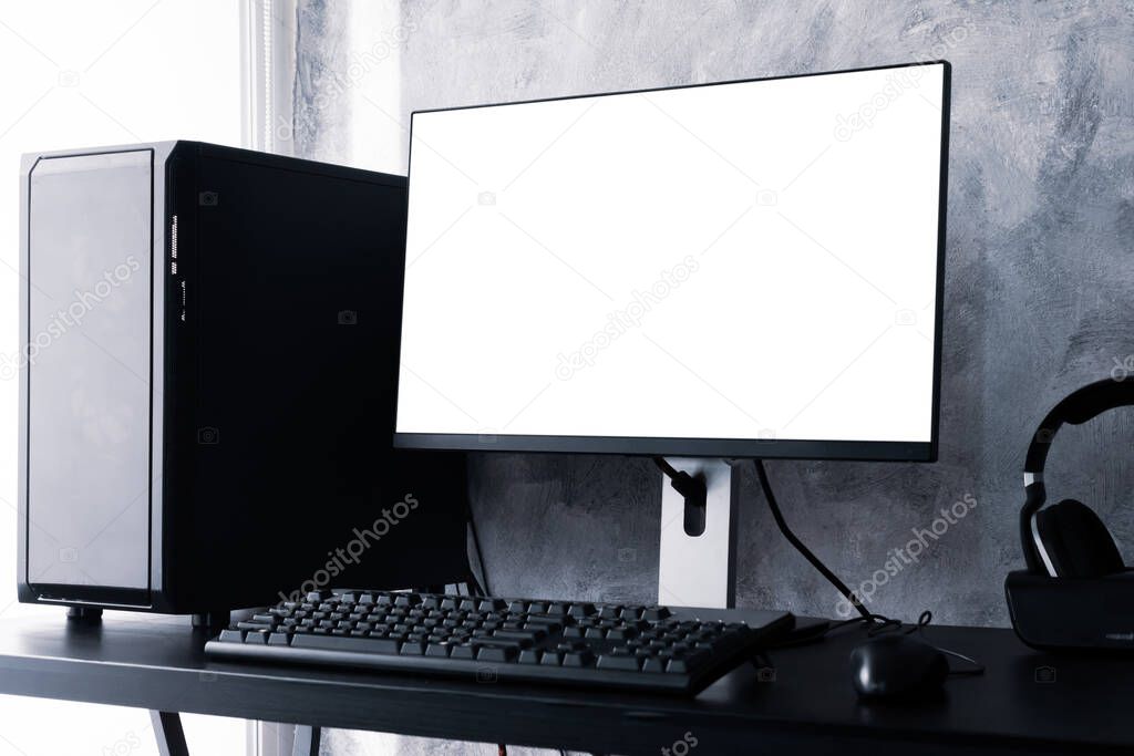 Black computer with white screen monitor on the desk.