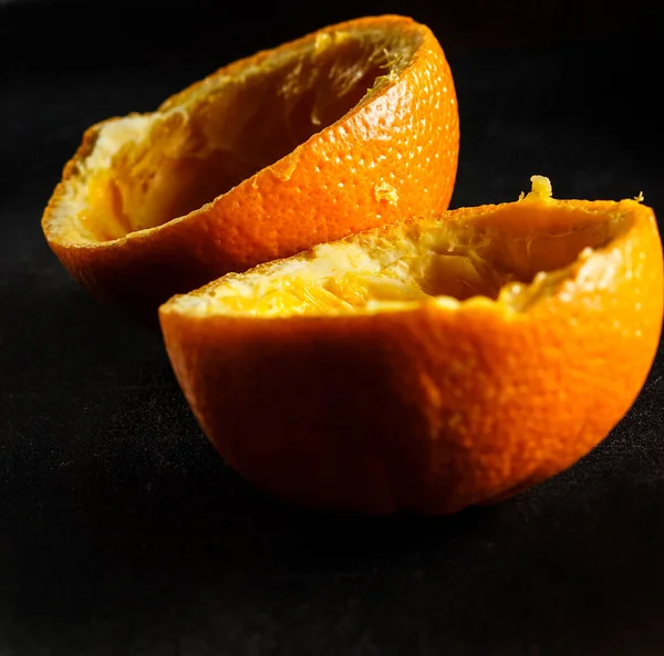 Used orange skins with dramatic light on black background. Square image.