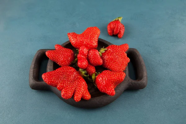 Ugly Strawberry Unusual Fruits Shape Berries In A Wooden Plate On A Blue Background Top View Stock Images Page Everypixel