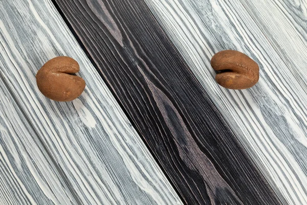 Ugly vegetables. Two funny potatoes with cracks on a black and white wooden textured background. Top view.