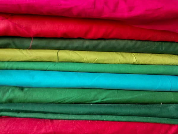 Lots red, green, blue, yellow, pink and other of clothes for sewed