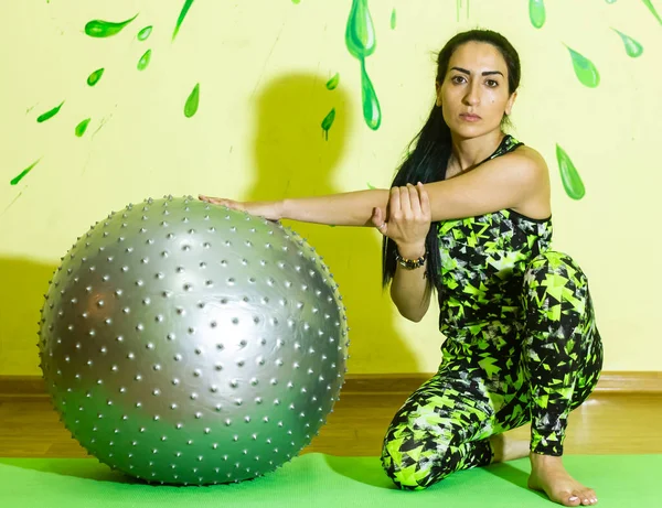 woman doing fitness exercise, young woman doing fitness exercises with fitness ball in fitness club
