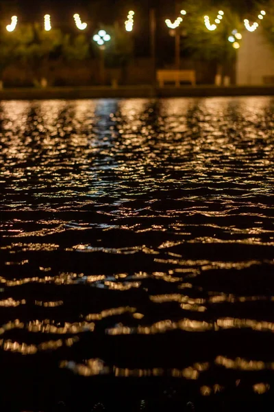 the reflection of lights in the night on the river