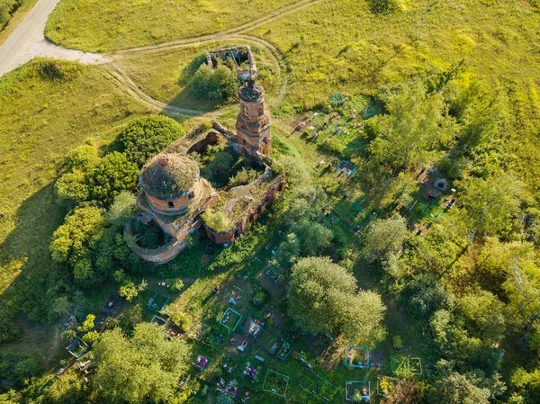 Aerial drone view, old ruined Church and cemetery in the field.