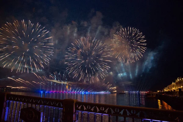 Colorful fireworks at night in St. Petersburg over the Neva for the annual celebration school graduates \
