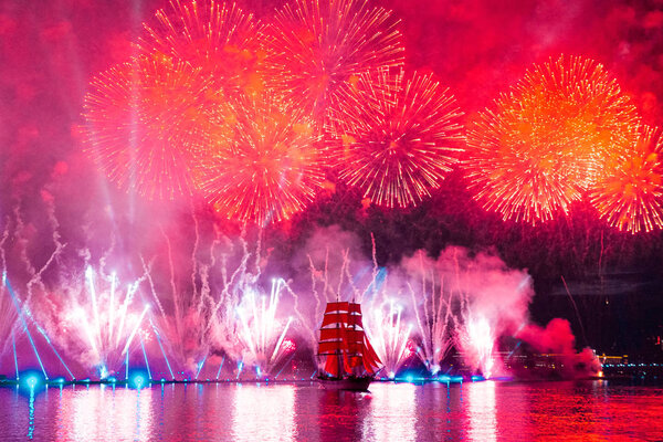 Saint-Petersburg, Russia-June 23,2018 Swedish brig Tre Krunur on the annual celebration school graduates Scarlet Sails in St. Petersburg. Festive fireworks and light show over the Neva river.