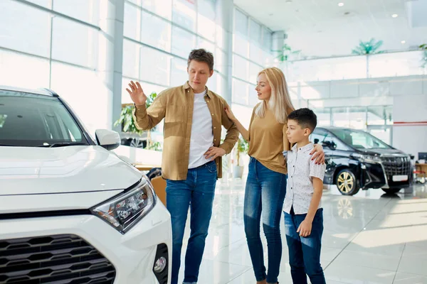 caucasian family liked luxurious auto in dealership