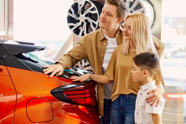 caucasian family liked luxurious auto in dealership