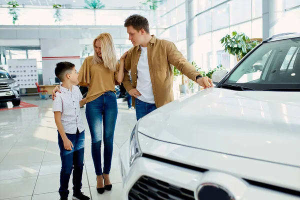 Criança com pais escolhendo novo automóvel — Fotografia de Stock