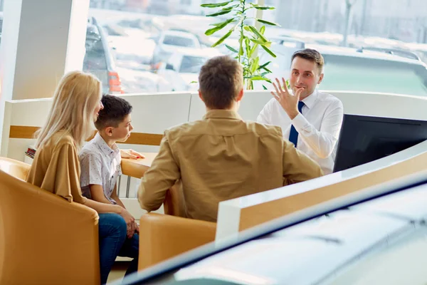 young caucasian family read documents and talk with consultant before purchase