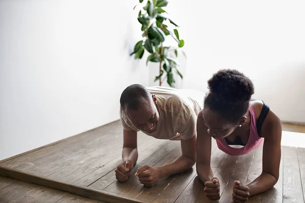 African man and woman do workout at home — Stock Photo, Image