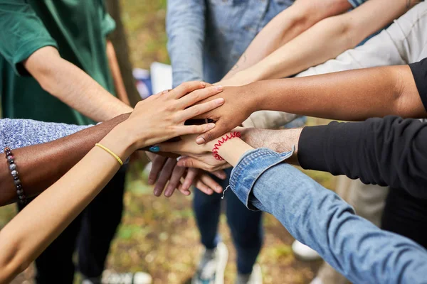 Close-up photo of diverse peoples hands gathered together — Stock Photo, Image