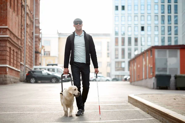 Blind man guided by puppy — Stock Photo, Image