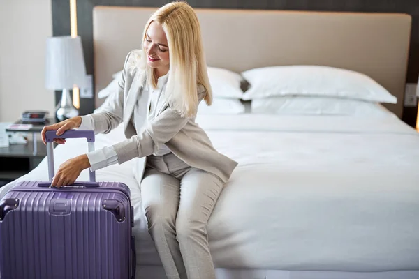 Mujer va a desempacar una maleta en el hotel — Foto de Stock