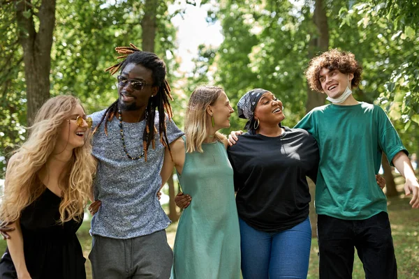 happy diverse people walk together in the park