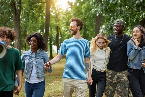 happy diverse people walk together in the park