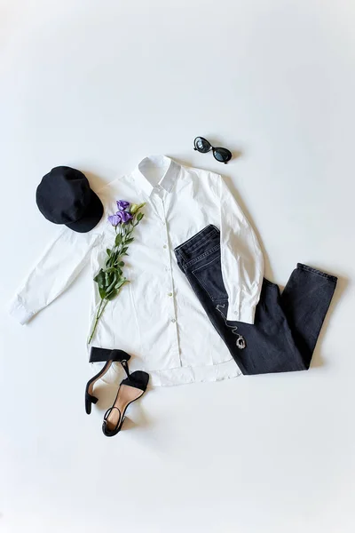 Flat lay female clothes and accessories.white blouse, black trousers, shoes, hat and sunglasses — Stock Photo, Image