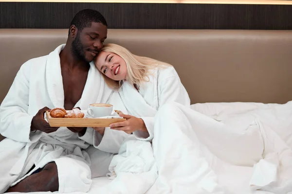 cute couple have breakfast on bed