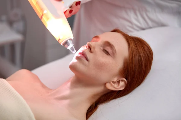 Young female on procedure of ultrasonic cleaning of face — Stock Photo, Image