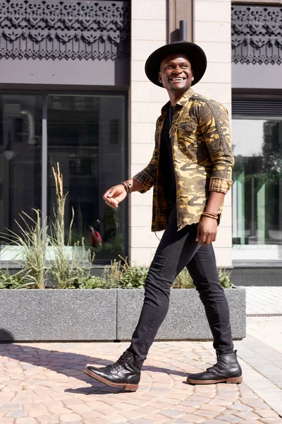 Hombre famoso afroamericano caminar en las calles de la ciudad, usando ropa de moda — Foto de Stock