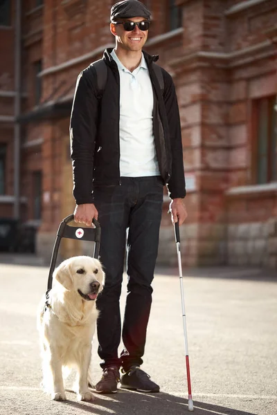 Eyeless guy with guide-dog — Stock Photo, Image