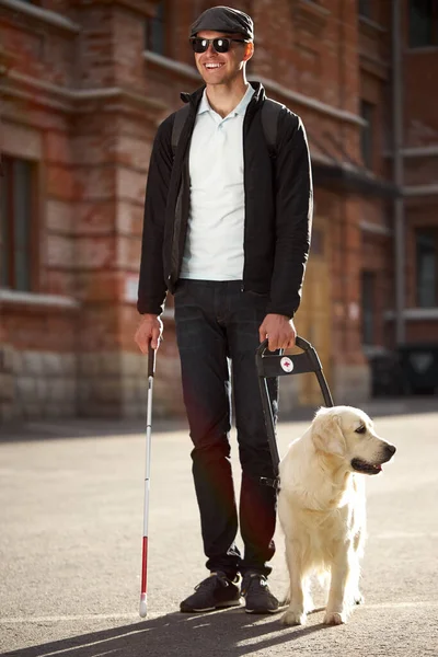 Portrait of positive blind male with golden retriever — Stock Photo, Image