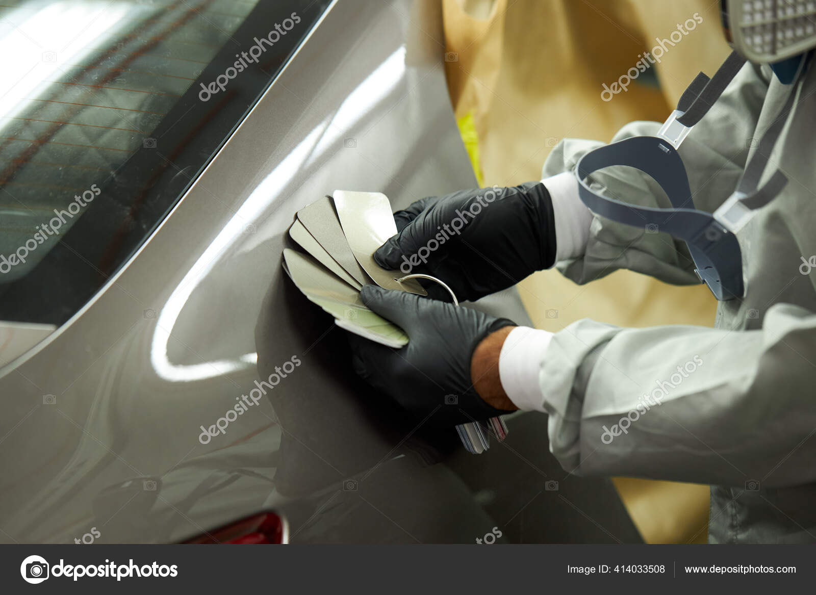 Auto mechanic shows colour palette for car painting Stock Photo by