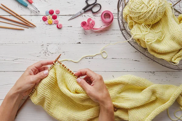 Female Hands Knitting Yellow Wool White Table Top View — Stock Photo, Image