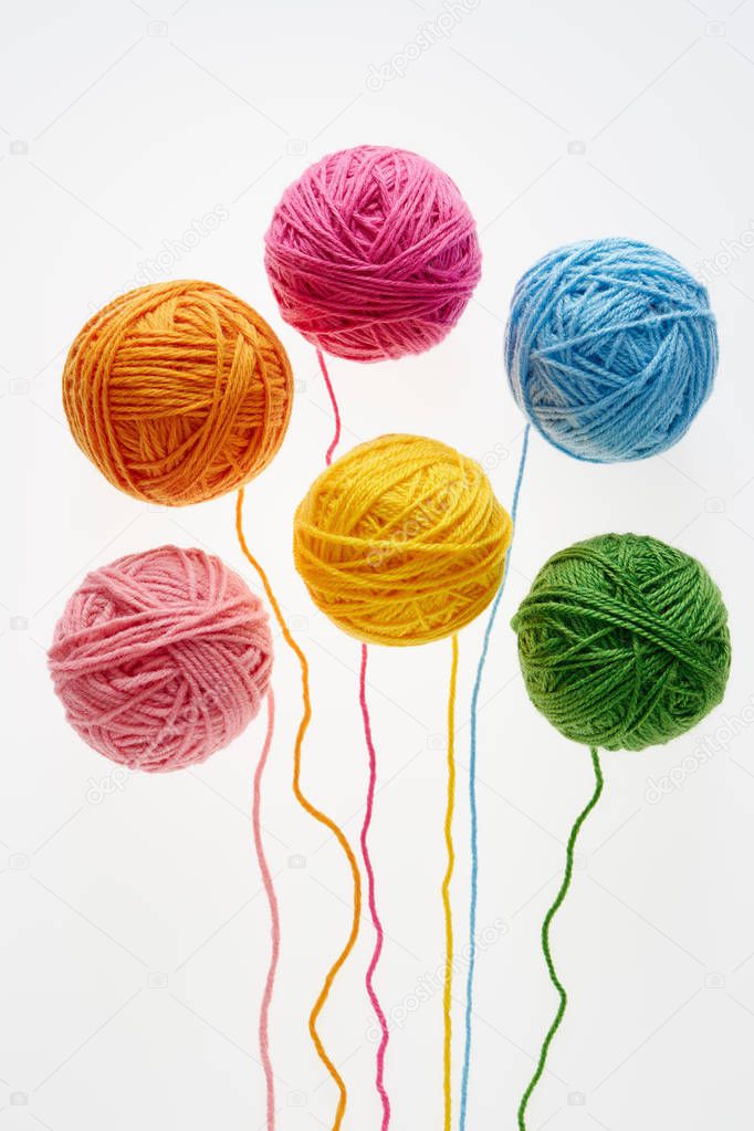 Colorful woolen balls over white background