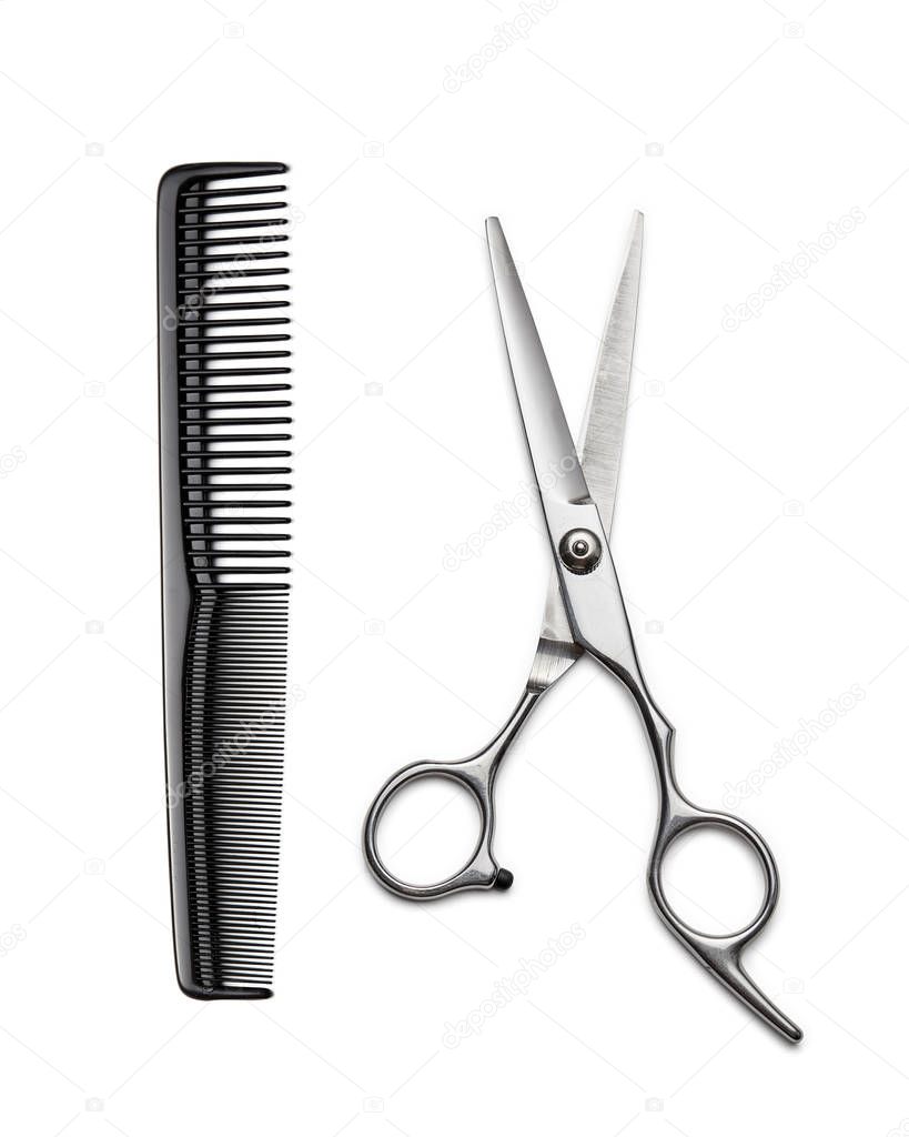 Hairdressers scissors and comb on white background