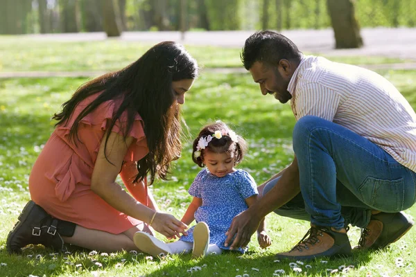 父と母は公園で彼らの小さな娘と遊んでいます — ストック写真