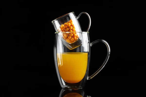 Medicinal sea buckthorn tea on a black background — Stock Photo, Image