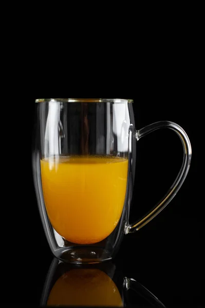 Medicinal sea buckthorn tea on a black background — Stock Photo, Image