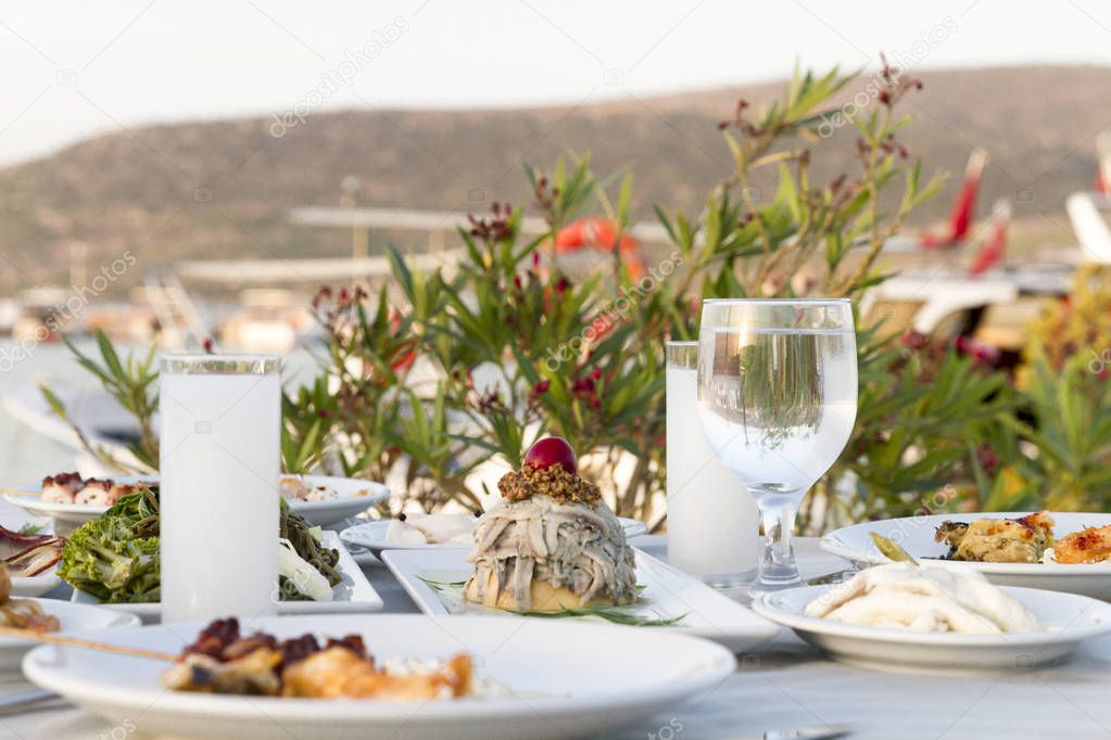 Table setting with different seafood meals at outdoor cafe 