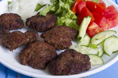 Yeşiller ve köfte ahşap arka plan üzerinde sebze salatası, yakın çekim